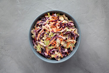 Homemade Coleslaw with Cabbage and Carrots in a Bowl, top view. Flat lay, overhead, from above. - obrazy, fototapety, plakaty