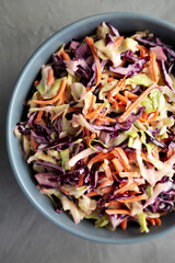 Homemade Coleslaw with Cabbage and Carrots in a Bowl, top view. Flat lay, overhead, from above.