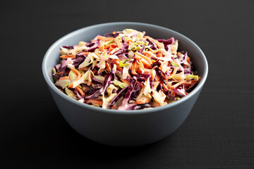 Homemade Coleslaw with Cabbage and Carrots in a Bowl, low angle view. Close-up.