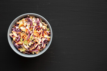 Homemade Coleslaw with Cabbage and Carrots in a Bowl, top view. Flat lay, overhead, from above. Space for text.