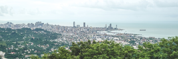 Fototapeta premium Panorama of the city at the foot of the mountain. Travel in the mountains, holidays in the mountains, hiking