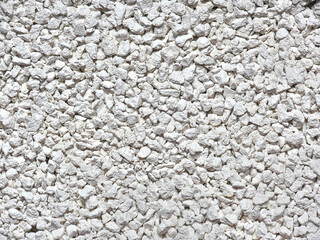 Close-up of cat litter or small porous white pebbles for texture or background.
