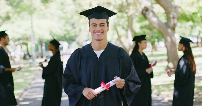 Portrait of a university student at a graduation ceremony outdoors. Young man holding a diploma while celebrating his accomplishment and achievement. Getting a good education for a successful future