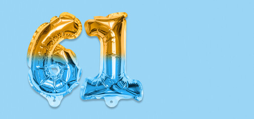 Rainbow foil balloon number, digit sixty one on a blue background. Birthday greeting card with inscription 61. Top view. Numerical digit. Celebration event, template. Banner