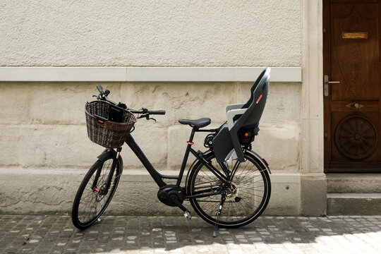 Selective focus picture of bicycle with sit carrier at the back in Zurich.