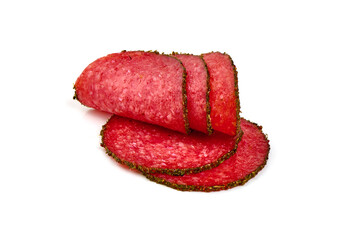 Peppered salami slices, isolated on white background.