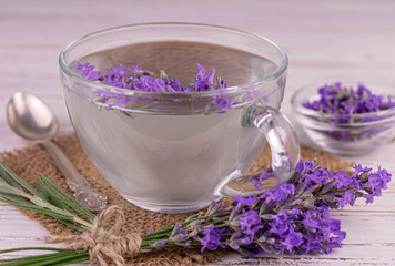 Obraz na płótnie Canvas Aromatic Aromatic lavender tea in a transparent cup.Close-up.davanda tea in a transparent cup.Close-up.