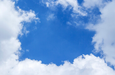 Blue sky background and white clouds soft focus, and copy space horizontal shape.