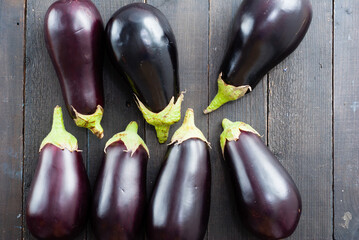 eggplants on black wood table background