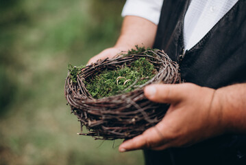 wedding rings in a decorative nest