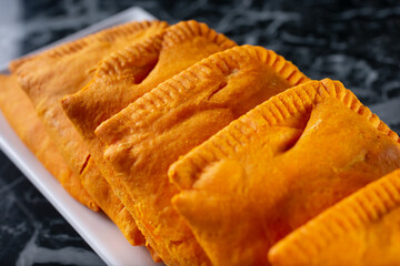 A view of a platter of Jamaican patties.