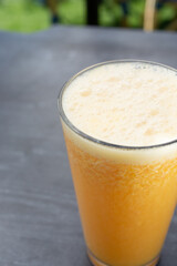 A view of a yellow blended juice.