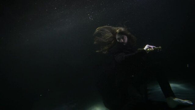 a long-haired man swings a sword in the dark water. the general plan