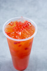 A view of a strawberry passionfruit fruit tea beverage.