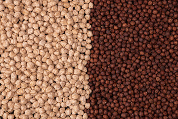 dark and white chickpeas as background texture, top view