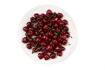ripe sweet cherries in ceramic bowl isolated on white background, group of red berries, top view