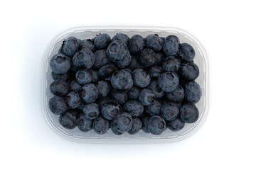 blueberries in plastic box isolated on white