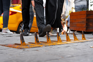 Close-up of yellow spikes for a tire puncture for stopping the car in a street of Istanbul