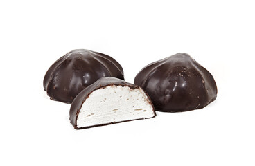 Close-up shot of whole marshmallows and one half covered with chocolate isolated on white background. Yummy mini dessert, closeup