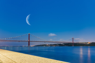 View of the 25th of April Bridge (25 de Abril in portuguese) at blue time