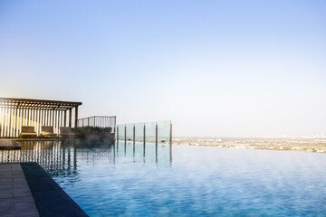 Sky swimming pool background, Cool Rooftop infinity pool background, 
Infinite rooftop pool overlooking the sky and clouds.