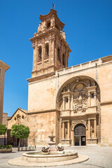 Fototapeta na wymiar View at the Church La Asuncion with fountain in the streets of Almansa in Spain