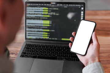 Young man using his laptop in cafe, close up