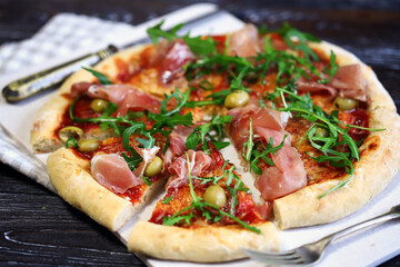 Pizza with jamon and arugula.