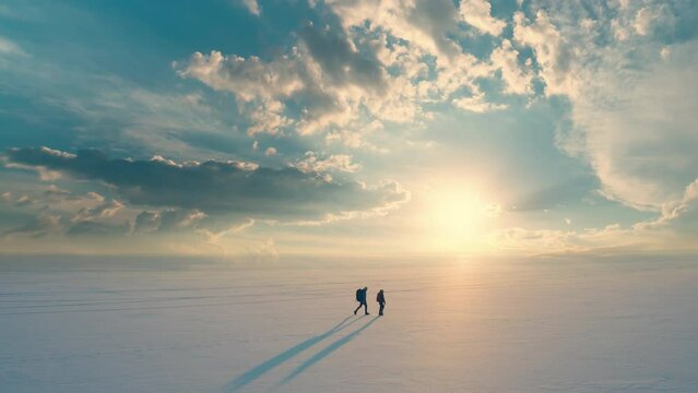 The two travelers going through the snow field