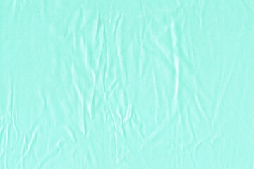 Light natural fabric of light blue color is crumpled. Background of natural fine fabric.