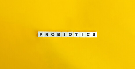 Probiotics Word and Banner. Text on Letter Tiles on Yellow Background. Minimal Aesthetics.