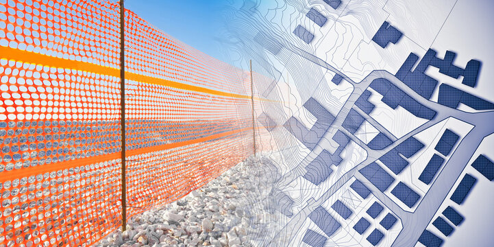 Construction site with safety orange plastic grid on a workplace against a city map - concept image