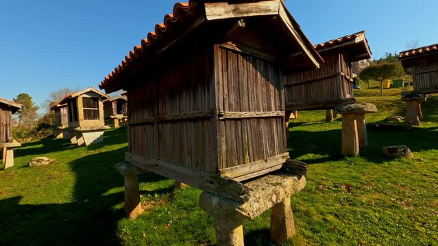 Traditional granaries in A Merca, Ouresence, Spain, circle pan, day