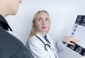Epileptologist examines patient MRI and electroencephalogram. Concept treating epilepsy and helping...