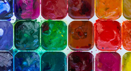 multicolored watercolor paints close-up, paint background