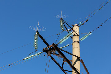 electricity pylon with glass insulators and bird spikes