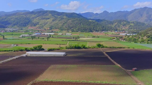 Clouds Shadowing Over Idyllic Agricultural Fields Near Constanza Valley In Dominican Republic. Aerial Wide Shot