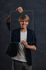 young man holding face portraits with different emotions