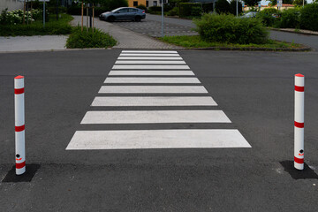 White pedestrian crossing across the carriageway.