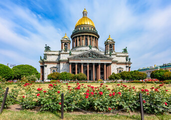 St. Isaac's cathedral and blooming roses in Saint Petersburg, Russia (translation "My temple will be called a temple of prayer")