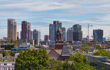 the skyline of rotterdam with new buildings and lot of greenery