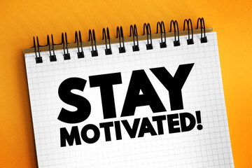 Stay motivated! text on notepad, concept background