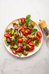 Top view of summer tomatoes croutons salad with pesto