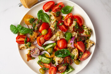 Top view of summer tomatoes croutons salad with pesto food