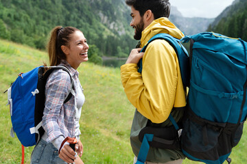 Fototapeta Hiking with friends is so fun. Group of young people with backpacks together obraz