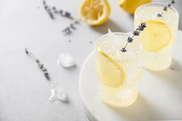 Sparkling summer lavender lemonade in glasses on gray background. Close up.