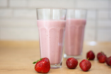 Homemade summer drink strawberry milkshake with strawberries copy the mockup space. Concept: homemade summer refreshing drinks 