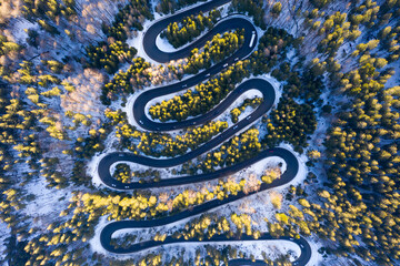 Aerial drone photograph bird's eye perspective of a beautiful winding mountain road in Romania in...