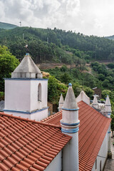 Roof, bell tower and round buttresses with spires of the parish church of Our Lady of Conceição,...