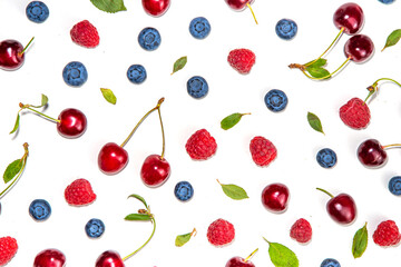 Mix of isolate blueberry, blackberry, raspberry, cherry and mint. Fresh ripe berry set isolated on white background